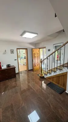 an empty living room with a staircase and a door at Villa FRIDA in Rogaška Slatina