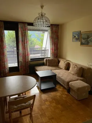 a living room with a couch and a table at Retro apartments Kaninska vas in Bovec