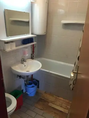 a bathroom with a sink and a bath tub at Retro apartments Kaninska vas in Bovec