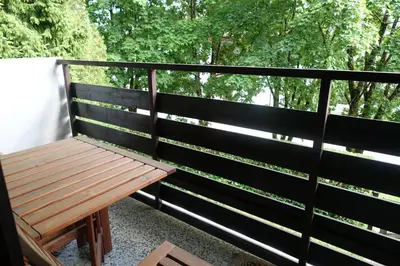 a wooden bench sitting on the side of a fence at Retro apartments Kaninska vas in Bovec
