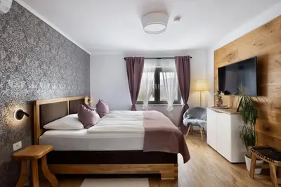 a hotel room with a bed and a desk at Hiša Vally Art in Bled