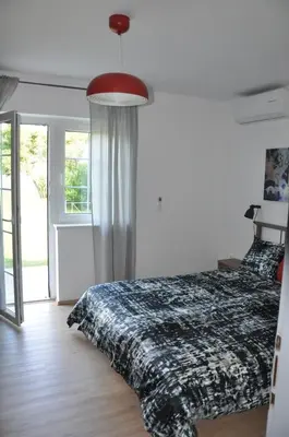 a bedroom with a bed and a large window at Vas Lipa 7 -30 in Podčetrtek
