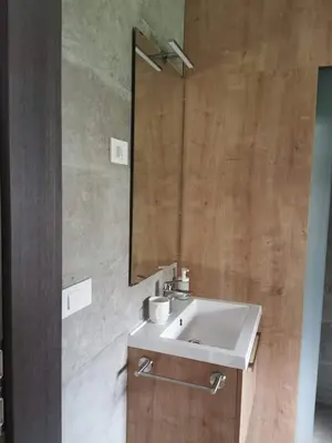 a bathroom with a sink and a mirror at Brand new house Luna in Bled