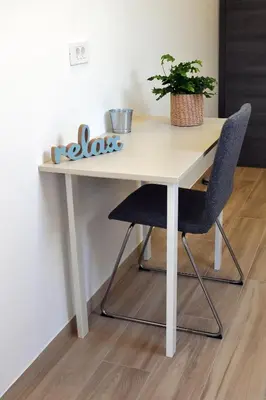 a white table with two chairs and a plant on it at Brand new house Luna in Bled