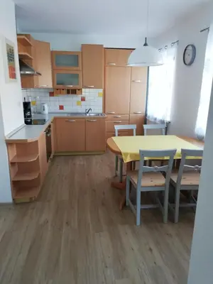 a kitchen with a yellow table and chairs at Apartma Vojvoda in Bohinj