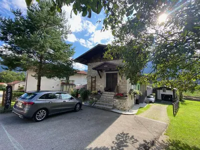 a car parked in front of a house at Apartma Skednj in Kobarid