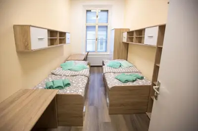 three beds in a small room with a window at MINIDORM ROOMS IN HEART OF CITY CENTER in Maribor