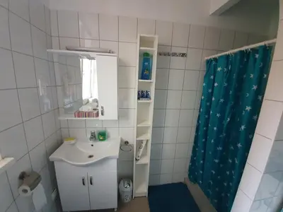 a bathroom with a sink and a shower curtain at MINIDORM ROOMS IN HEART OF CITY CENTER in Maribor