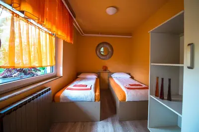 two beds in a small room with a window at Apartma Rombon Brdo with Free Onsite Parking in Bovec
