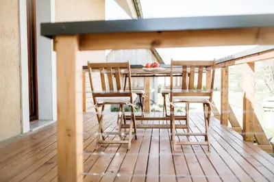 a table and chairs sitting on a porch with a table at Mama Mia Apartments in Radovljica