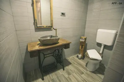 a bathroom with a sink and a toilet at Mama Mia Apartments in Radovljica