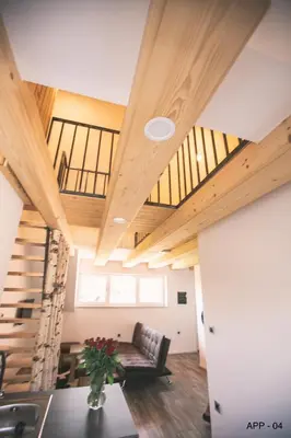 a living room with a couch and wooden ceilings at Mama Mia Apartments in Radovljica