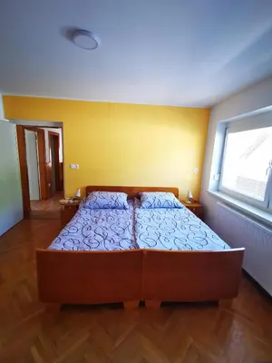 a bedroom with a bed in a room at Apartmaji Tomšič in Mojstrana