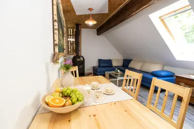 a dining room table with a bowl of fruit on it at Apartma waterfall Slap in Bohinj
