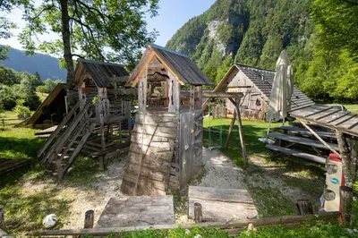 a playground with a slide and a play structure at Apartma waterfall Slap in Bohinj