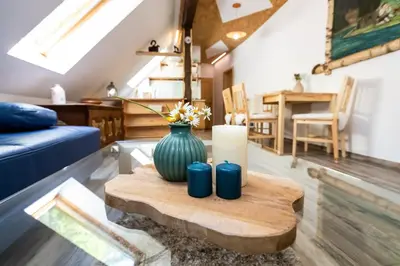 a living room with a vase and candles on a table at Apartma waterfall Slap in Bohinj