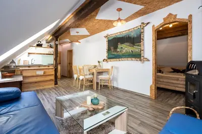 a living room with a couch and a table at Apartma waterfall Slap in Bohinj