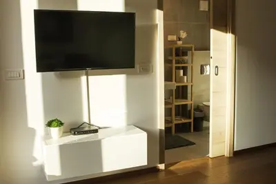 a living room with a flat screen tv on a wall at Ski and Bike Apartment Rušovc in Kranjska Gora