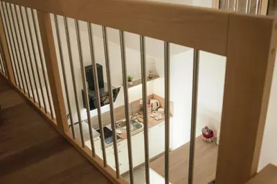 a room with a stair railing with a television on it at Ski and Bike Apartment Rušovc in Kranjska Gora