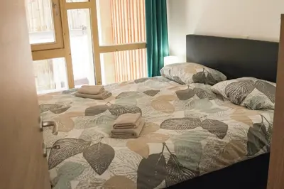 a bed with two pillows on top of it at Ski and Bike Apartment Rušovc in Kranjska Gora