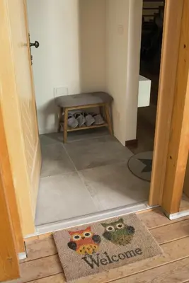 a hallway with a table and a rug on the floor at Ski and Bike Apartment Rušovc in Kranjska Gora