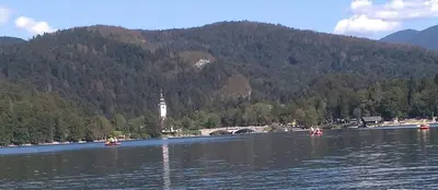 a body of water with people in boats on it at Apartma in studio Jerca ob Savi in Bohinj