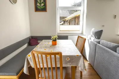a small dining room with a table and chairs at Apartma in studio Jerca ob Savi in Bohinj