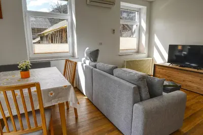 a living room with a couch and a table at Apartma in studio Jerca ob Savi in Bohinj
