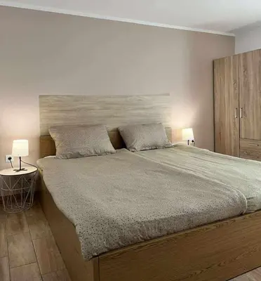 a bedroom with a large bed with two lamps at Rooms Osmica- Videm pri Ptuju in Videm pri Ptuju