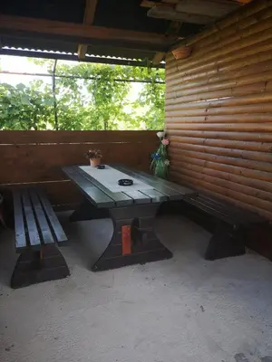 a picnic table and a bench in a cabin at Rooms Osmica- Videm pri Ptuju in Videm pri Ptuju