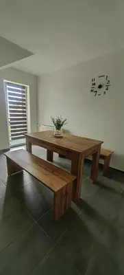 a wooden table and bench in a room at Rooms Osmica- Videm pri Ptuju in Videm pri Ptuju