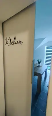 a sign that says kitchen on the side of a building at Rooms Osmica- Videm pri Ptuju in Videm pri Ptuju