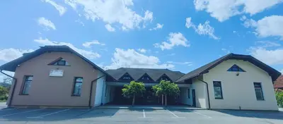 two white buildings with a blue sky in the background at Rooms Osmica- Videm pri Ptuju in Videm pri Ptuju