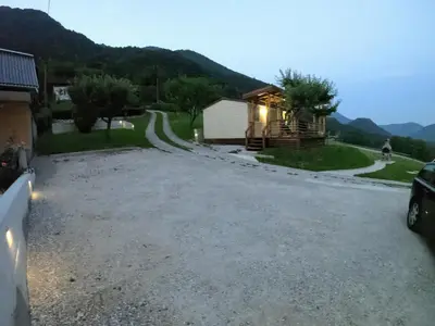a gravel driveway with a house in the background at Holiday HOUSE NEAR THE SOČA RIVER in Tolmin