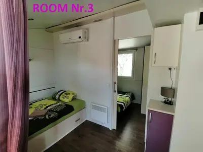 a small room with two beds in a room at Holiday HOUSE NEAR THE SOČA RIVER in Tolmin