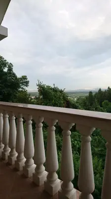 a white railing on a balcony with a view at Apartma Dolomiti in Ljubljana