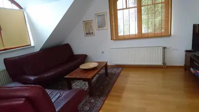 a living room with a couch and a table at Apartma Dolomiti in Ljubljana