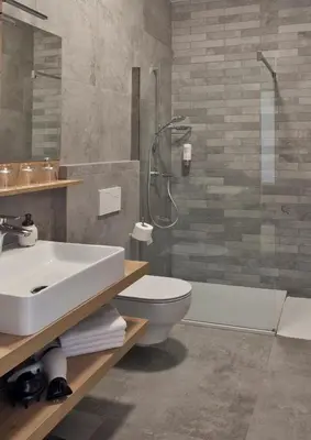 a bathroom with a sink and a toilet and a shower at Guesthouse Turšič in Vrhnika
