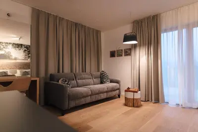 a living room with a couch and a table at Hotel Majerca Superior in Bohinj