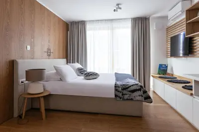a bedroom with a large bed and a window at Hotel Majerca Superior in Bohinj