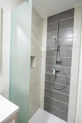 a shower with a glass door in a bathroom at Guesthouse Urša in Preddvor