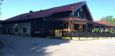 a building with a brown roof on a street at Guesthouse Urša in Preddvor