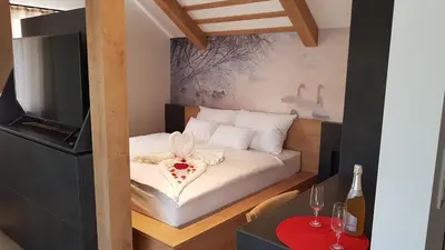 a small bedroom with a bed with a heart on it at Chalet Zana in Bled