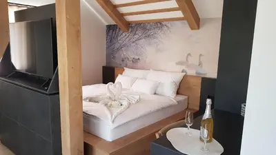 a small bedroom with a bed and a television at Chalet Zana in Bled