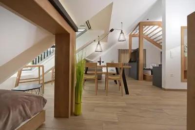 a bedroom and dining room with a table and chairs at Chalet Zana in Bled