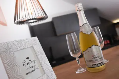 a bottle of champagne sitting on a table next to a glass at Chalet Zana in Bled