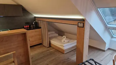 a small room with a bed in the attic at Chalet Zana in Bled