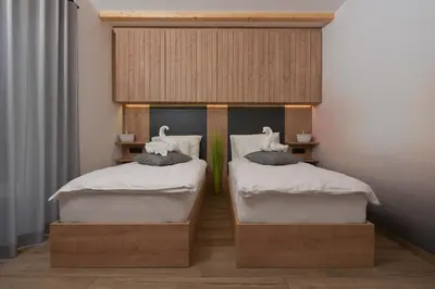 two beds with swans on them in a room at Chalet Zana in Bled