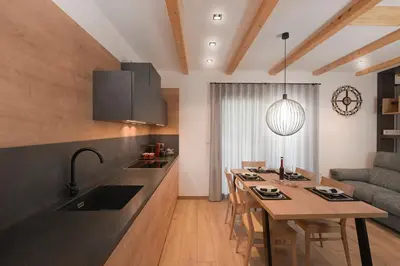 a kitchen with a table and a dining room at Chalet Zana in Bled