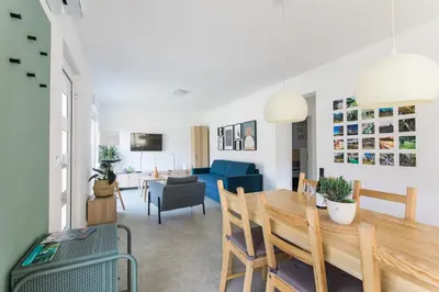 a living room and dining room with a table and chairs at Positive sport apartments in Kobarid